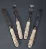 Ornately Pierced and Carved Ivory Handled Set of Two Knives and Two Forks. 