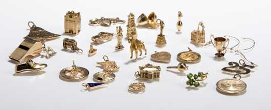 Twenty Seven Yellow Gold Charms and Pin.