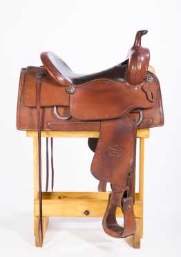 Western Saddle-McLelland, a two tone leather saddle with barbed wore tooling