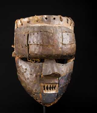 A fine and old copper clad Salampasu face mask--Ex. Kamer