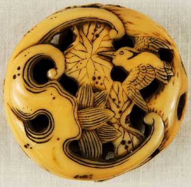 An Ivory Manju, carved and pierced in Ryusa style