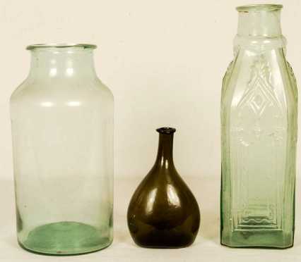 Two Green Glass Storage Jars And A Bottle