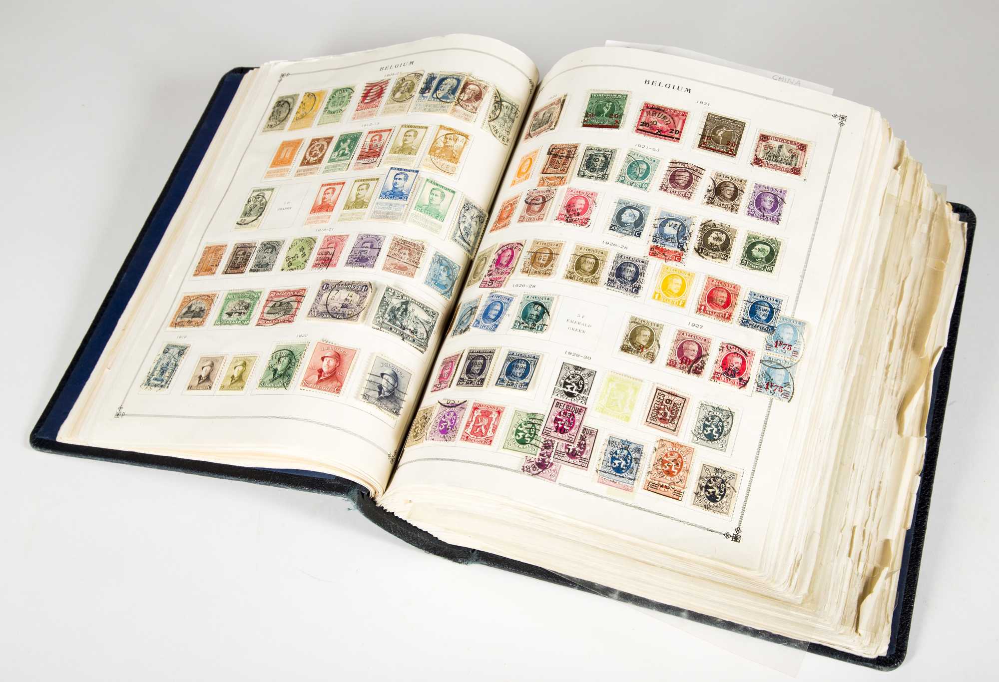 Lot - STAMPS: Housed in two albums, beginner collection of stamps,  International Junior Postage Stamp album, copy-write 1943, along with a  small stock book; all of the stamps are on hinges with