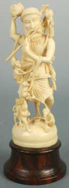 Carved Ivory Figure of a man playing the flute