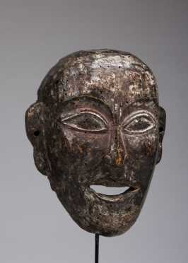 A mask depicting a young monk