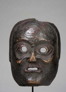 A mask depicting an old grimacing woman